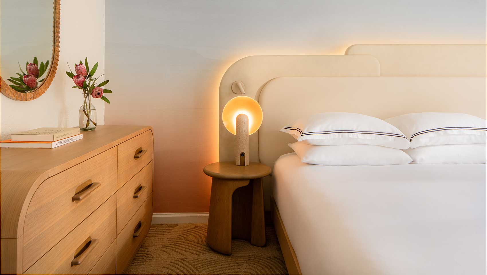 Bed, side table, lamp and dresser in a canyon casita