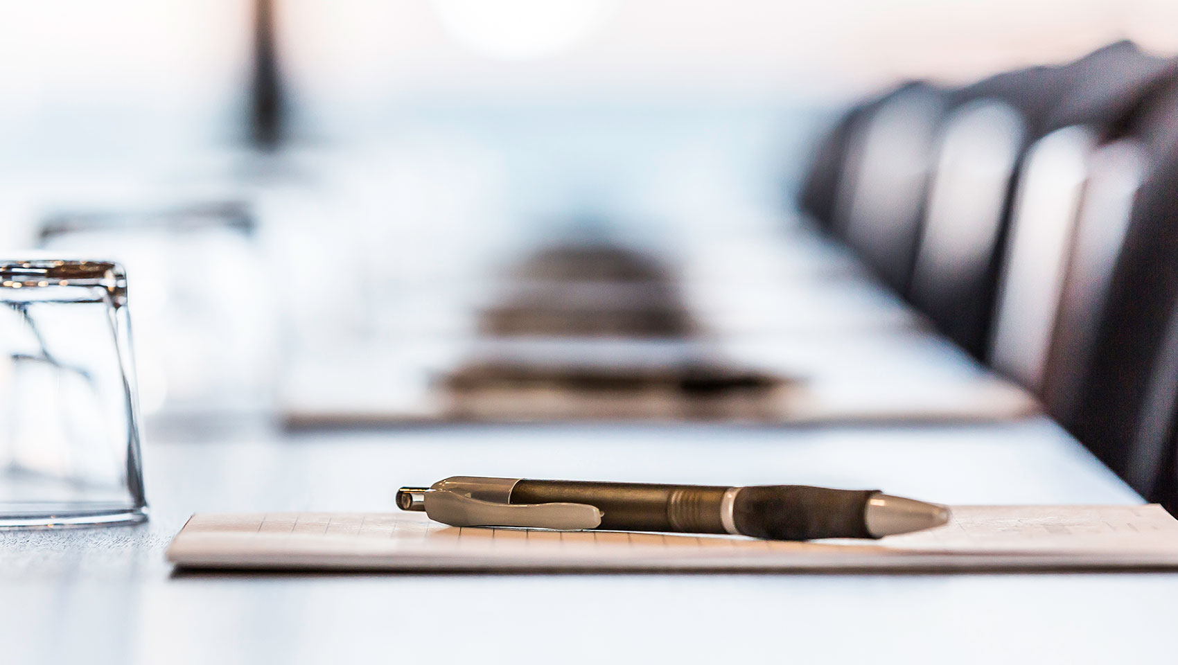 pen and notepad on conference table