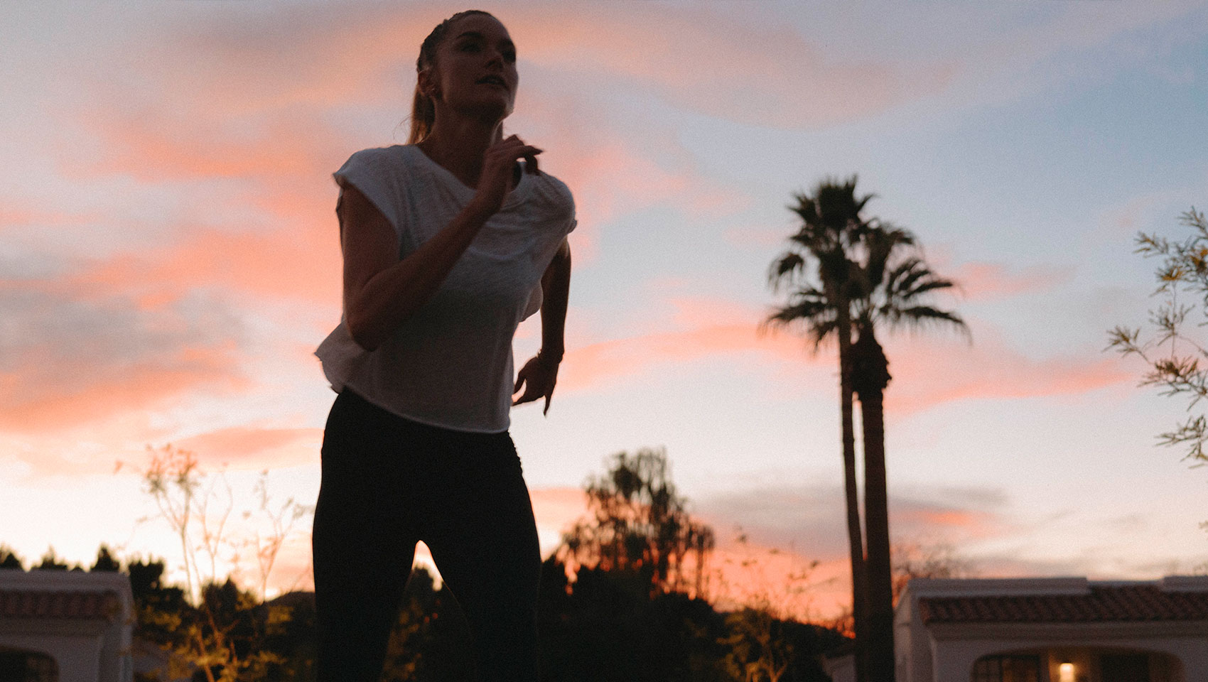 woman running outside at Kimpton Miralina at dawn or dusk