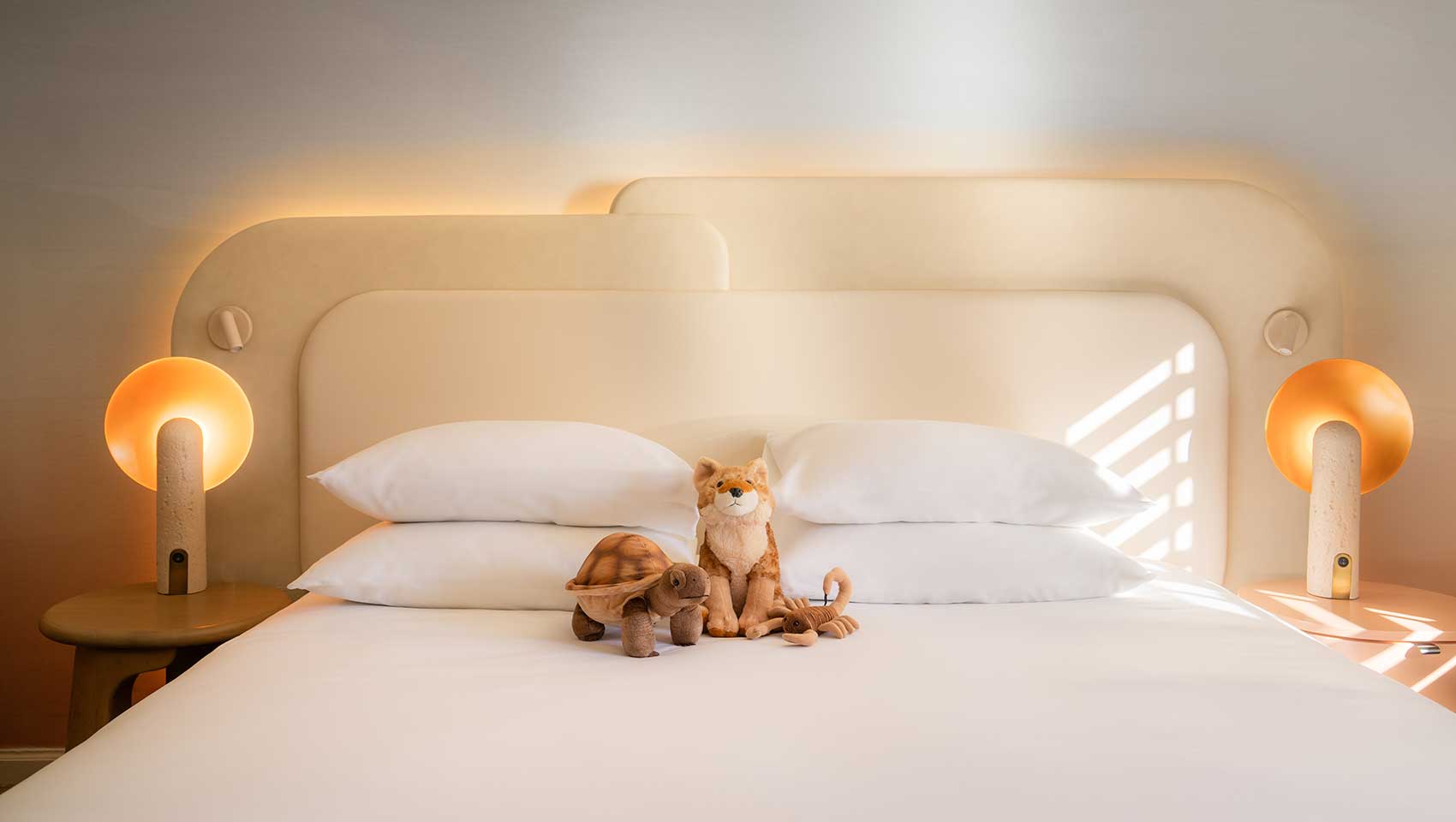 Sutffed animals on king bed at Kimpton Miralina