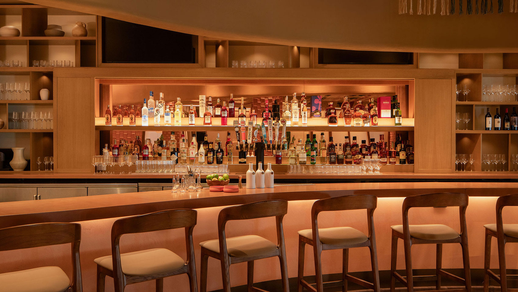 Kimpton Miralina dining area with polished wood tables and desert-inspired ambiance