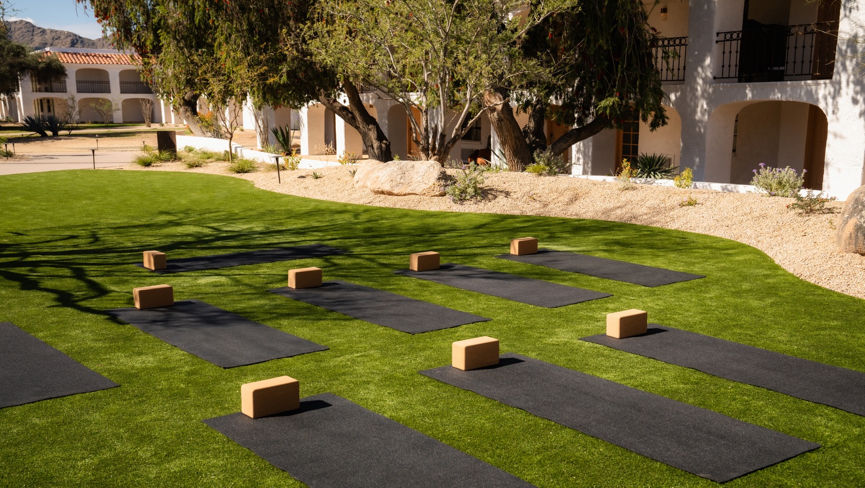 black yoga mats and yoga blocks set up outside at Kimpton Miralina