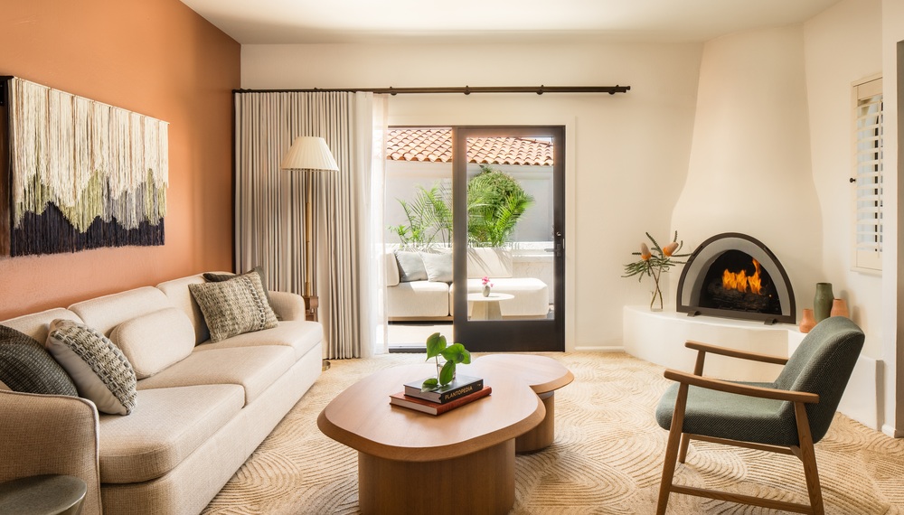 Valey Villa interior with sofa, chair, coffee table and fireplace