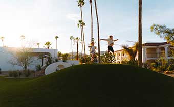 kids jumping on grass