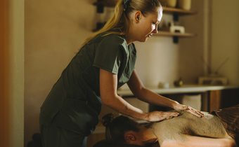 guest receiving mud massage
