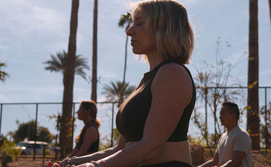 woman does outdoor yoga at Kimpton Miralina