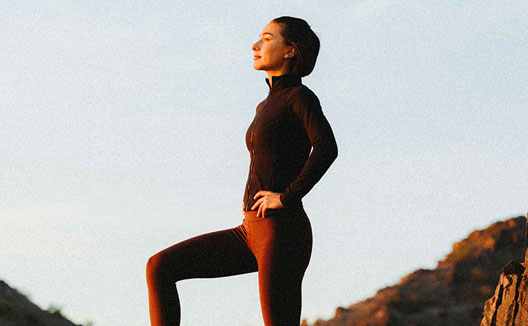 woman standing on rocks during hike
